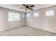 Bedroom with a ceiling fan and three windows overlooking the neighborhood at 5540 Palomino Way, Frederick, CO 80504