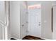 Bright entryway featuring white doors, and dark hardwood floors, creating a clean and inviting space at 5540 Palomino Way, Frederick, CO 80504