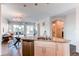 Open-concept kitchen with granite island, stainless steel appliances, and seamless flow to the living area at 5540 Palomino Way, Frederick, CO 80504