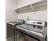 Laundry room featuring a washer and dryer with shelf at 5540 Palomino Way, Frederick, CO 80504