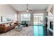 Inviting living room with a leather sofa, ceiling fan, and sliding glass doors leading to the deck at 5540 Palomino Way, Frederick, CO 80504
