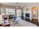 Comfortable living room with a fireplace, large windows, and a relaxing ambiance at 5540 Palomino Way, Frederick, CO 80504