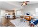 Open living space with a kitchen, dining area, and living room, featuring hardwood floors and plenty of light at 5540 Palomino Way, Frederick, CO 80504