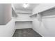 View of walk-in closet with shelves, storage racks and grey carpet at 5540 Palomino Way, Frederick, CO 80504