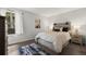 This bedroom has a stylish bed frame and headboard with artwork and natural light at 7710 W 87Th Dr # K, Arvada, CO 80005