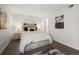 The bedroom has a light wood frame bed, side tables, and decorations at 7710 W 87Th Dr # K, Arvada, CO 80005