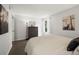 Bedroom with dark dresser, large window, decorative lighting, and a neutral color scheme at 7710 W 87Th Dr # K, Arvada, CO 80005