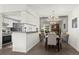 Open floor plan view of dining and kitchen area. Updated features and stylish lighting at 7710 W 87Th Dr # K, Arvada, CO 80005