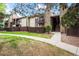 Landscaped condo exterior with stone details and a well-maintained lawn and walkway at 7710 W 87Th Dr # K, Arvada, CO 80005