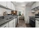 Bright kitchen with stainless steel appliances that opens up to the living area with a fireplace at 7710 W 87Th Dr # K, Arvada, CO 80005