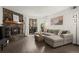 Comfortable living room featuring a stone fireplace and a contemporary sectional sofa at 7710 W 87Th Dr # K, Arvada, CO 80005