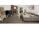 Inviting living room with a stone fireplace, a stylish sectional, and modern decor at 7710 W 87Th Dr # K, Arvada, CO 80005