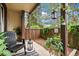 Serene, covered patio with comfortable seating and a view of the landscaped yard at 7710 W 87Th Dr # K, Arvada, CO 80005