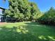 A vast backyard with lush lawn and mature trees, providing ample space for recreation and relaxation at 4196 S Reading Way, Denver, CO 80237