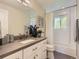 Bathroom featuring a shower over tub with a curtain and white vanity at 4196 S Reading Way, Denver, CO 80237