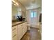 Bright bathroom featuring white vanity, modern fixtures, and shower-tub combo at 4196 S Reading Way, Denver, CO 80237