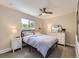 Bedroom features a large window, light-colored walls, and a stylish ceiling fan at 4196 S Reading Way, Denver, CO 80237