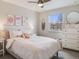 Stylishly decorated bedroom with colorful artwork and a large window at 4196 S Reading Way, Denver, CO 80237