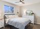 Bright bedroom with large window, ceiling fan, and modern decor at 4196 S Reading Way, Denver, CO 80237