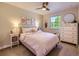 Bright bedroom with a ceiling fan, a large window, and cheerful decor at 4196 S Reading Way, Denver, CO 80237