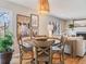 Dining area featuring wooden table and chairs with a woven light fixture above at 4196 S Reading Way, Denver, CO 80237