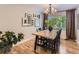 Elegant dining room with modern chandelier, hardwood floors, and abundant natural light at 4196 S Reading Way, Denver, CO 80237