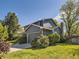Exterior view of a two-story home with gray siding, well-manicured lawn, and a two-car garage at 4196 S Reading Way, Denver, CO 80237