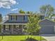 Charming two-story home with a manicured lawn and an attached two-car garage at 4196 S Reading Way, Denver, CO 80237