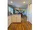 Bright and modern kitchen featuring white cabinets, stainless steel appliances, and a view of the Gathering room at 4196 S Reading Way, Denver, CO 80237