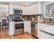 Modern kitchen featuring stainless steel appliances, stylish backsplash, and ample counter space at 4196 S Reading Way, Denver, CO 80237