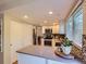 Well-designed kitchen with stainless appliances, white cabinets, and eat-in counter space at 4196 S Reading Way, Denver, CO 80237