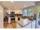 Modern kitchen with stainless steel appliances, stylish backsplash, and ample counter space at 4196 S Reading Way, Denver, CO 80237