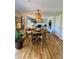 Open-concept living area with hardwood floors, a cozy fireplace, and stylish decor at 4196 S Reading Way, Denver, CO 80237