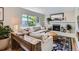 Cozy living room with a white brick fireplace, comfortable seating, and a large window at 4196 S Reading Way, Denver, CO 80237