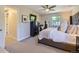 This main bedroom showcases carpeted floors, a ceiling fan, and a large black dresser at 4196 S Reading Way, Denver, CO 80237