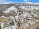 Aerial view of the neighborhood, showcasing snow-covered landscape and the home's expansive driveway at 16323 River Haven Way, Morrison, CO 80465