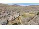 Picturesque aerial view showcasing the community's golf course, pond, walking path, and mountain backdrop at 16323 River Haven Way, Morrison, CO 80465