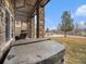 Backyard view showing covered hot tub, covered patio with stone pillars, and beautiful landscaping at 16323 River Haven Way, Morrison, CO 80465