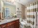 Well-lit bathroom features a single sink vanity, shower and bathtub combination with decorative tile at 16323 River Haven Way, Morrison, CO 80465
