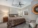 Cozy bedroom with tray ceilings, decorative ceiling fan, carpeted floors, and a window at 16323 River Haven Way, Morrison, CO 80465