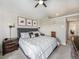 This bedroom features a gray tufted headboard, matching side tables, and a ceiling fan at 16323 River Haven Way, Morrison, CO 80465