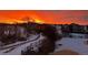Exterior view of a community of homes and beautiful sunrise at 16323 River Haven Way, Morrison, CO 80465
