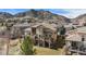 Beautiful two-story home with a tile roof, multiple balconies, stone columns, and mountain views at 16323 River Haven Way, Morrison, CO 80465