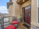 Charming front porch features seating and a decorative welcome bear, offering a cozy entrance at 16323 River Haven Way, Morrison, CO 80465