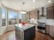 Modern kitchen with stainless steel appliances, island with wine cooler, and natural light at 16323 River Haven Way, Morrison, CO 80465