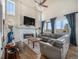 Bright living room boasts high ceilings, fireplace, and large windows offering scenic views at 16323 River Haven Way, Morrison, CO 80465