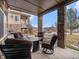 Inviting covered patio features stone columns, a fire pit, and comfortable seating for outdoor relaxation at 16323 River Haven Way, Morrison, CO 80465
