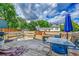 This cozy wooden back deck features benches and a table, plus an umbrella at 4848 S Pitkin Way, Aurora, CO 80015