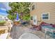 This cozy wooden back deck has a dining table, plus an umbrella and metal tub at 4848 S Pitkin Way, Aurora, CO 80015