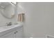 This bathroom features a white vanity and mirror, and a towel rack for convenience at 4848 S Pitkin Way, Aurora, CO 80015